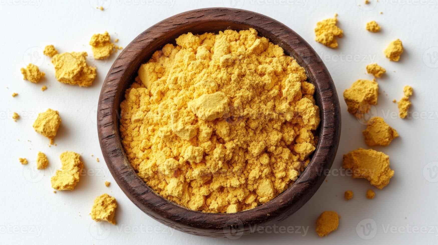 Tumeric powder in a wooden bowl photo