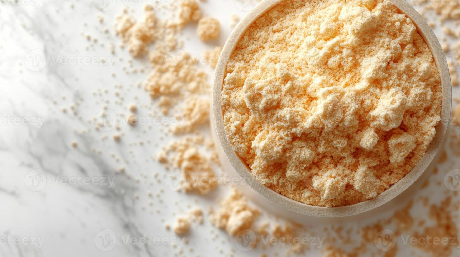 A bowl of powdered sugar on a marble surface photo