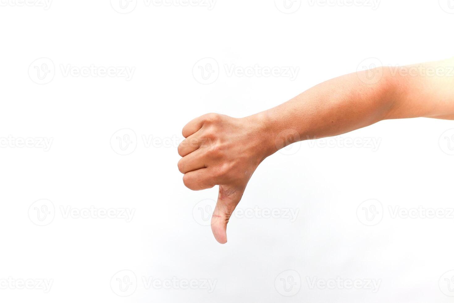 Human hand displaying thumb down against bright white backdrop studio shot photo