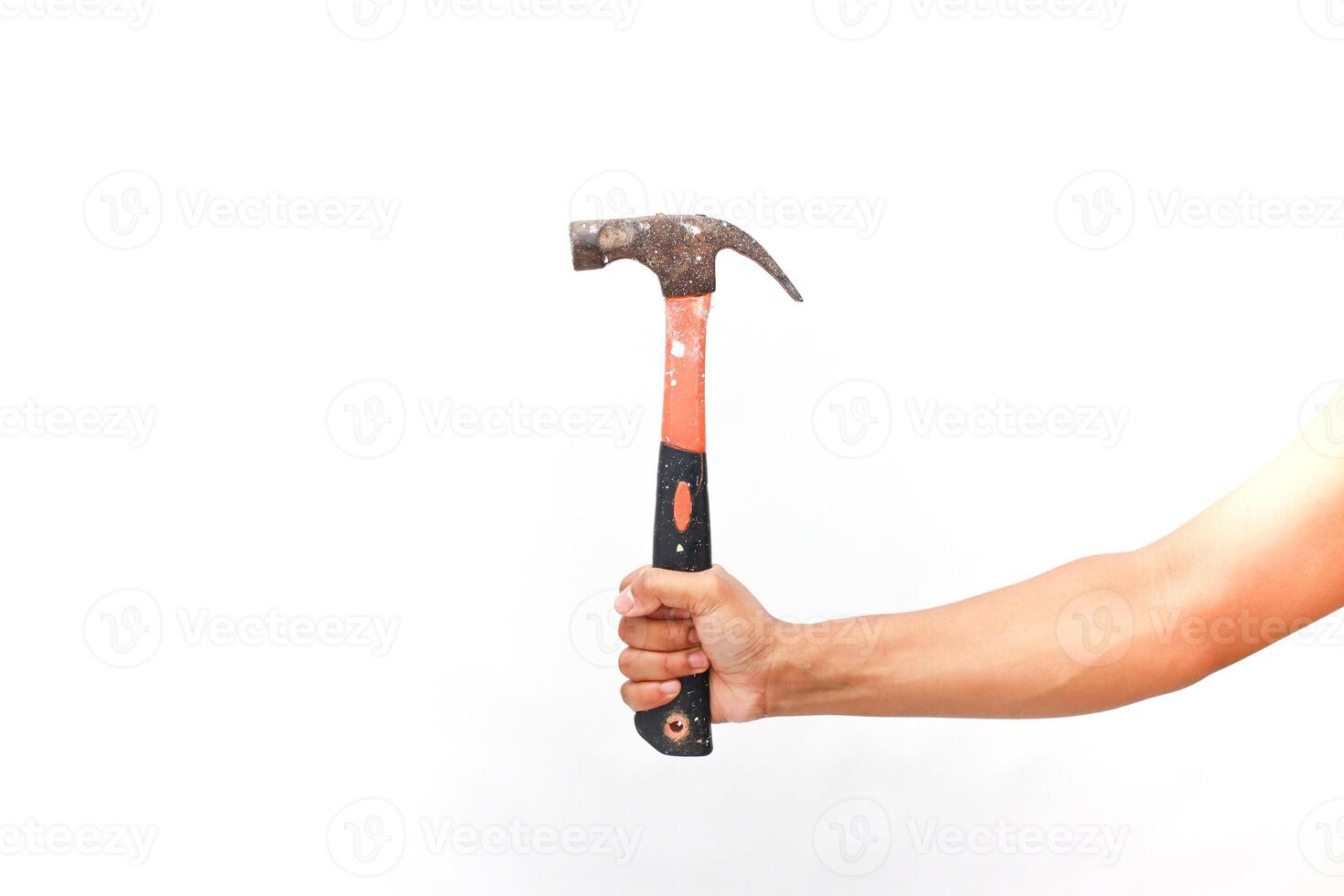 A worker's hand confidently holding a worn hammer against a pristine white background photo