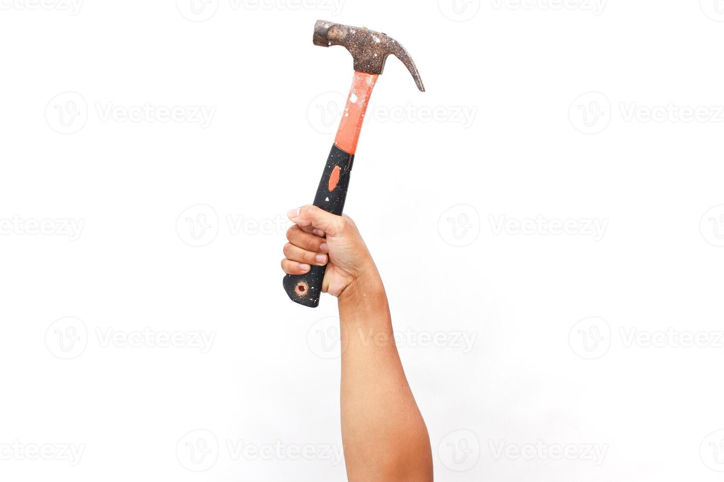 Hand gripping a weathered hammer, symbolizing construction and craftsmanship photo