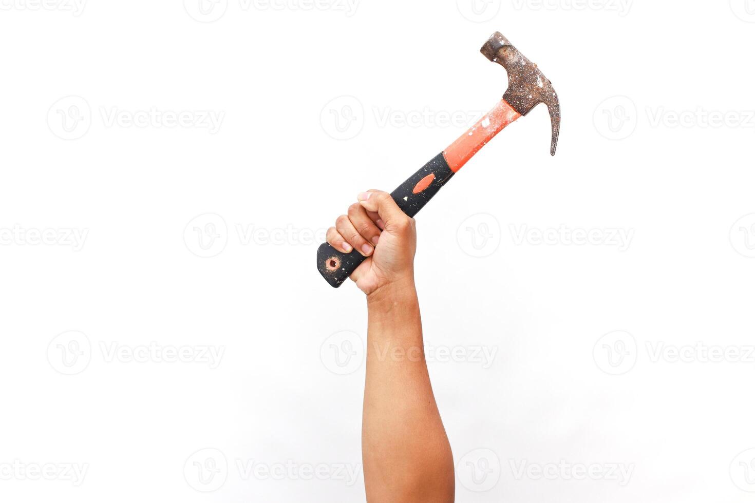 Raised hand holding a rusty hammer against a clean white backdrop studio shot photo