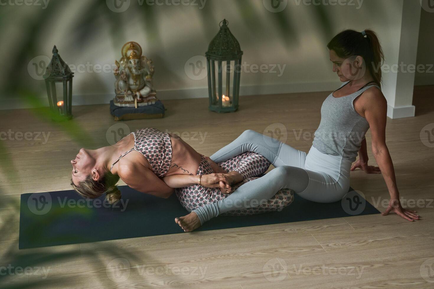 Sportswomen stretching together during training photo