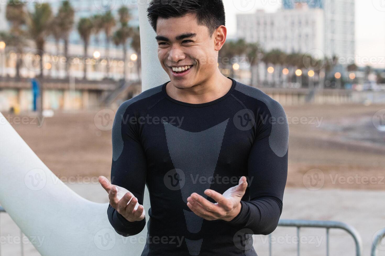 Cheerful athletic man with powdered hands photo