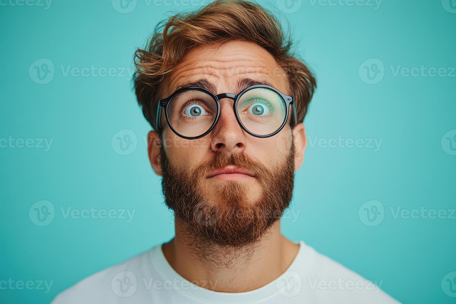 A man with glasses on his face looking up photo