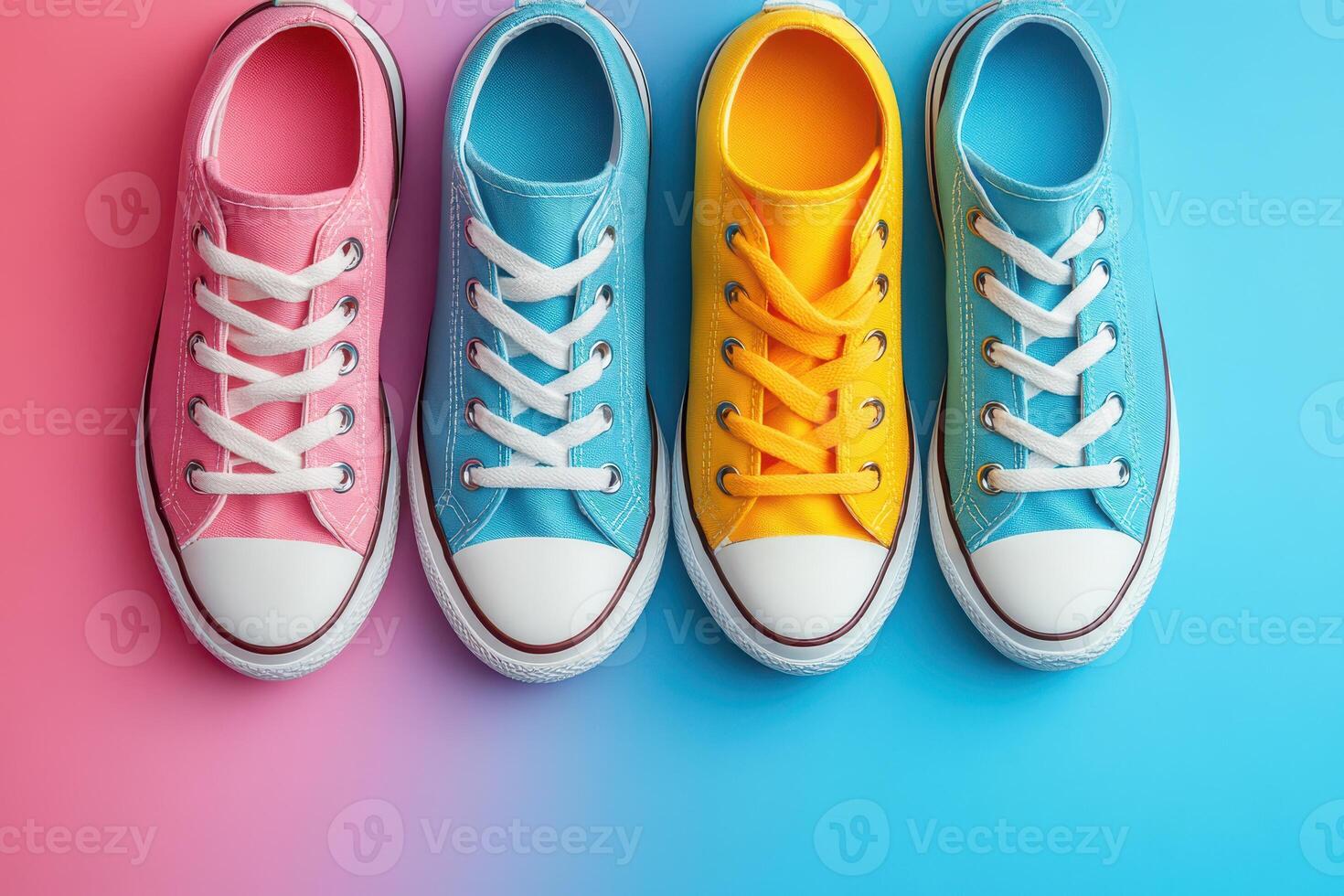 Three pairs of colorful sneakers on a blue and pink background photo