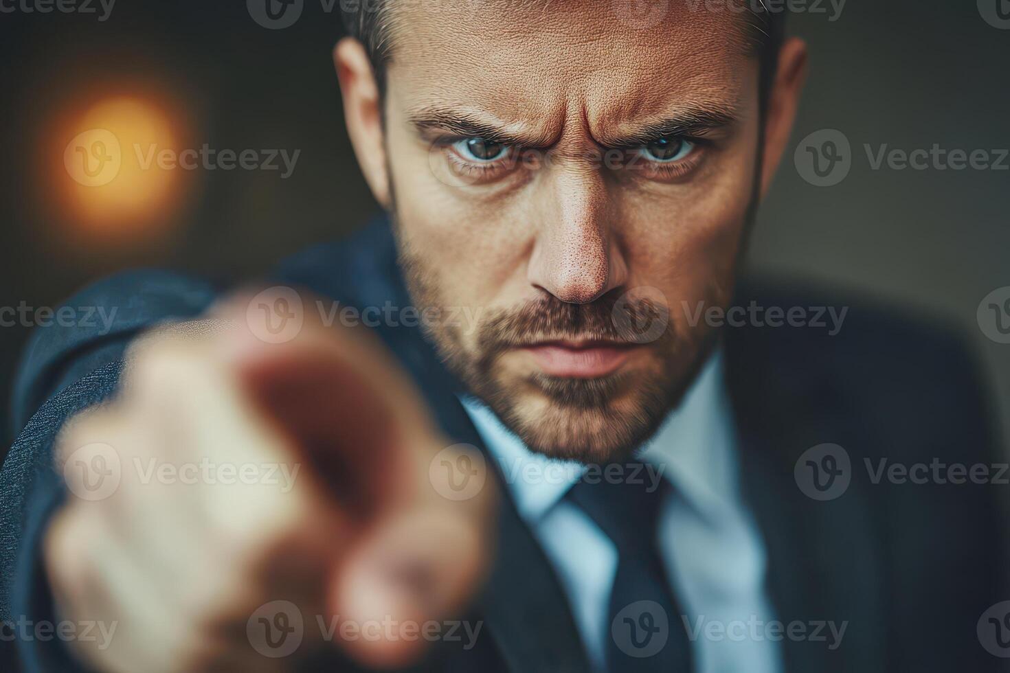 A man in a suit pointing at something photo