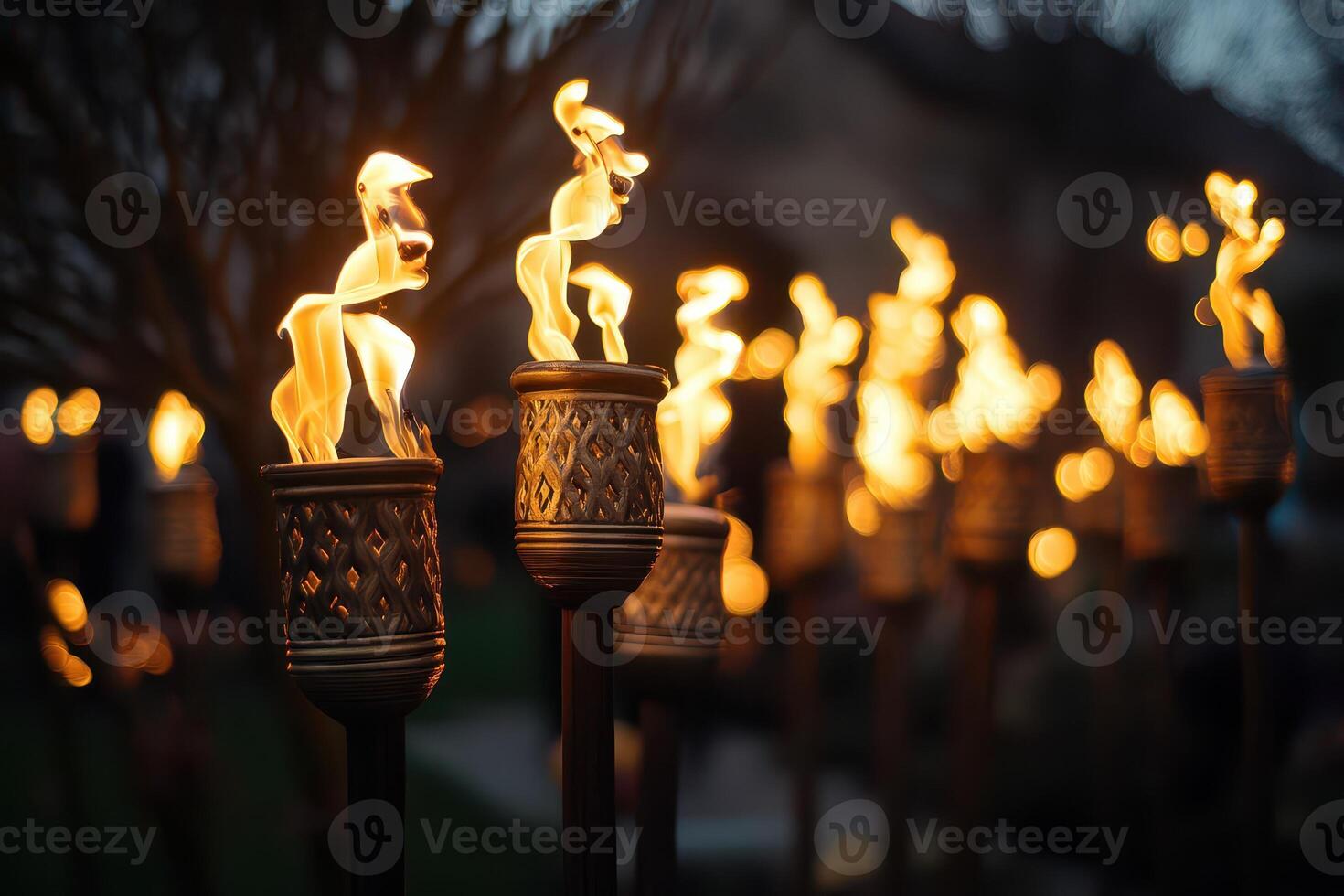 A row of torches lit up with flames photo