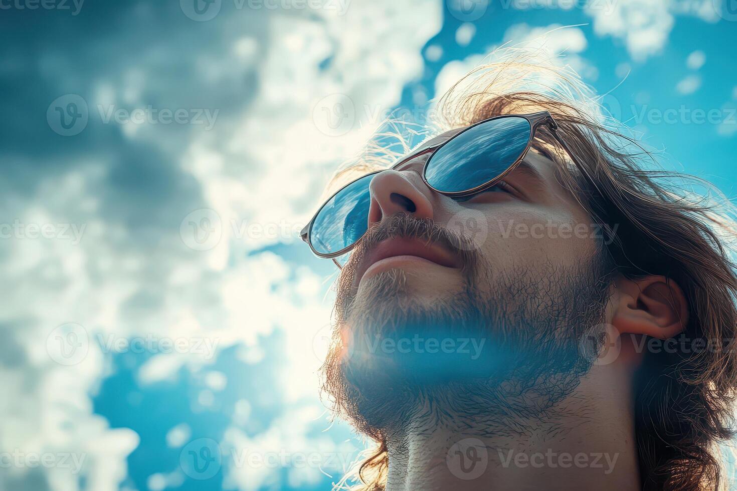A man with sunglasses looking up at the sky photo