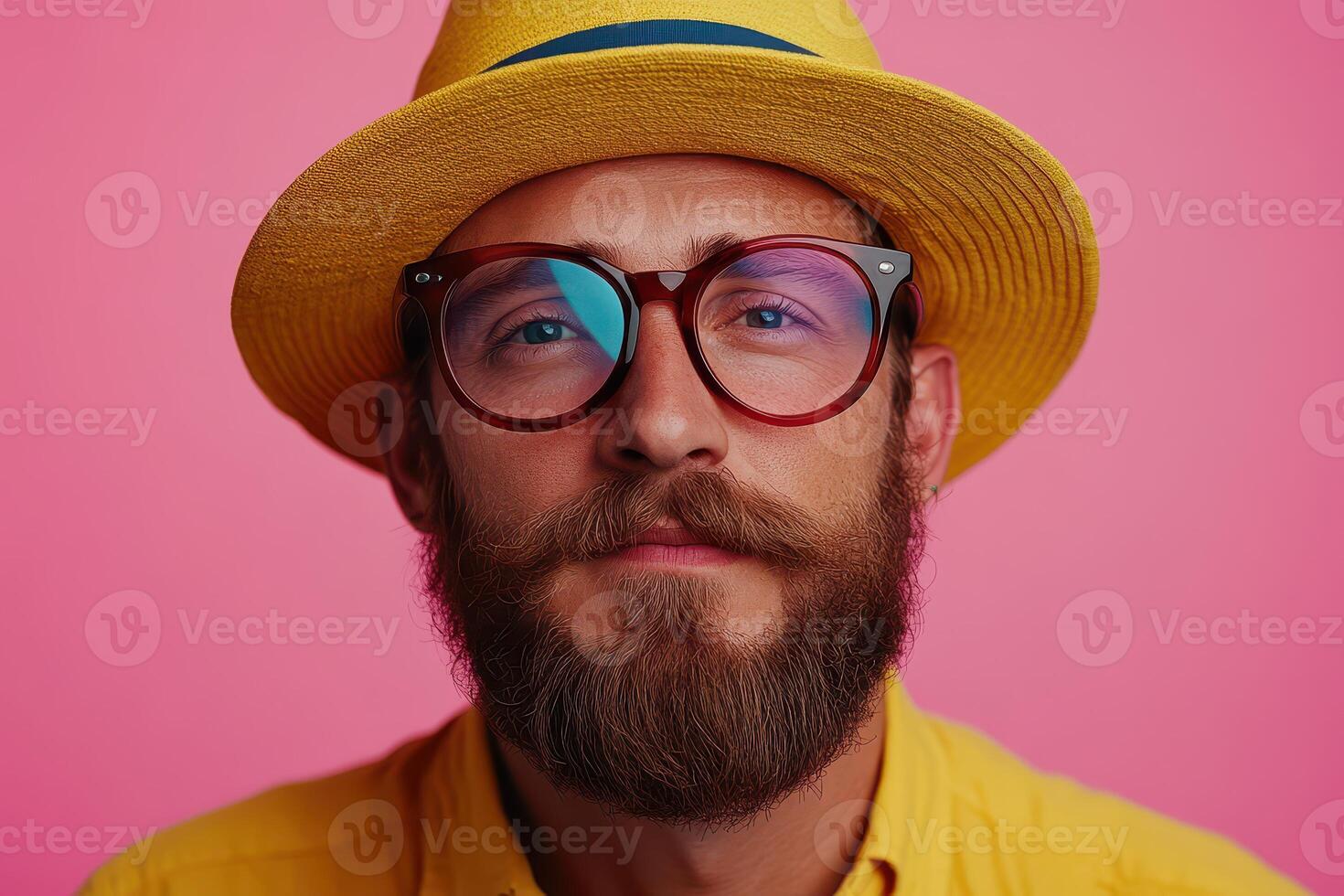 A man with a beard and glasses wearing a yellow hat photo