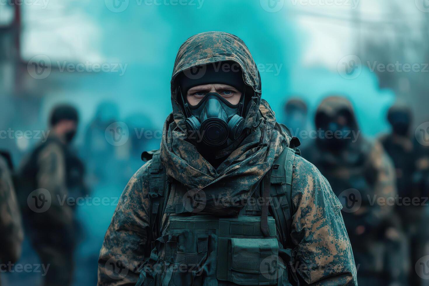 A man in a gas mask and camouflage gear is standing in front of a group of people photo