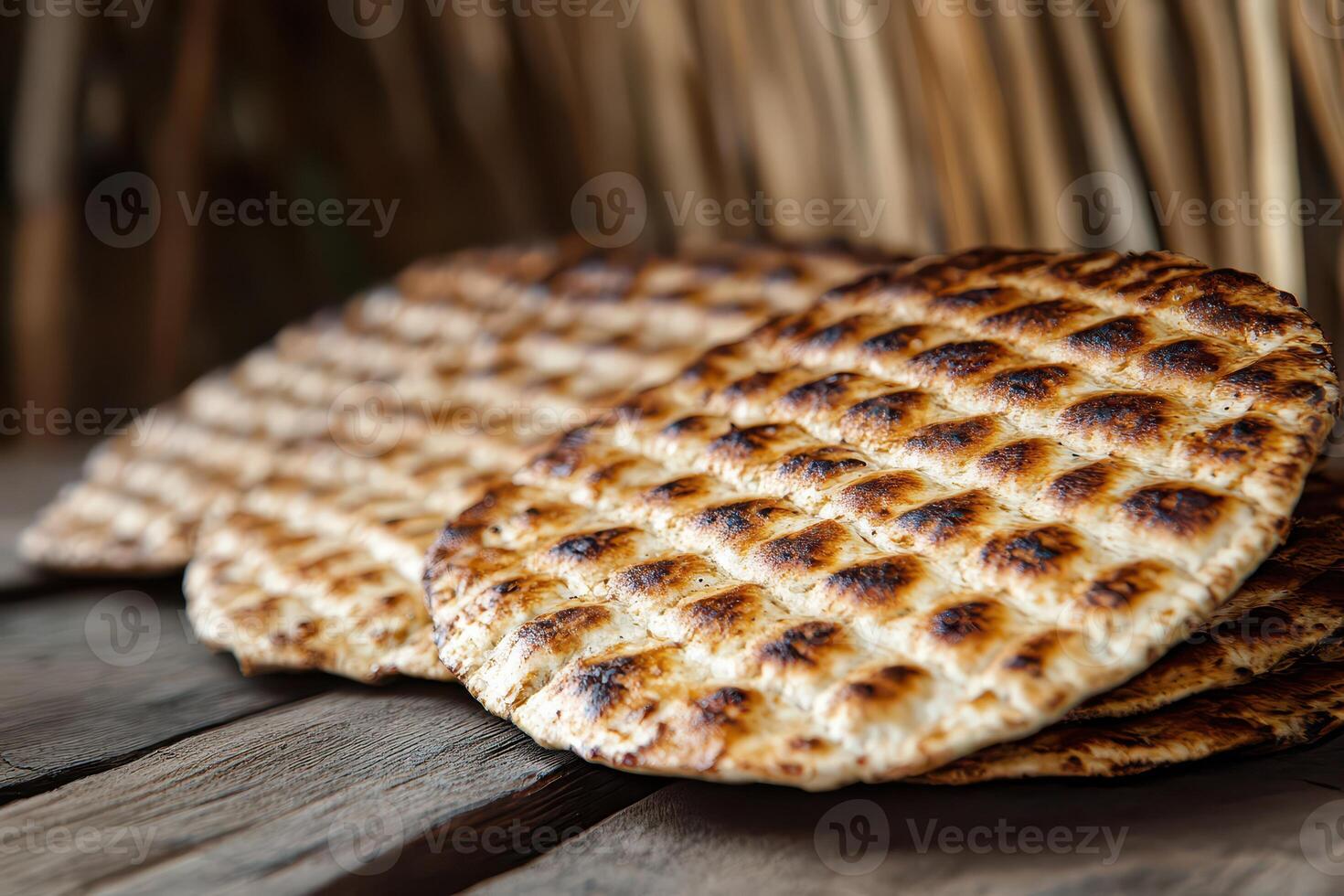 A stack of flat breads on a wooden table photo