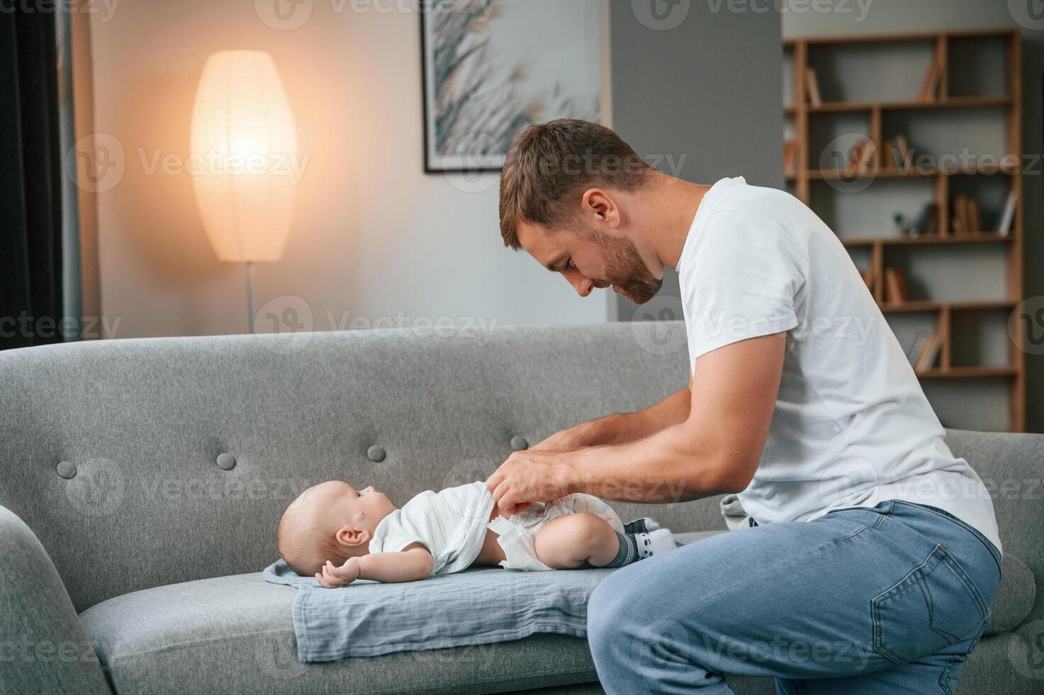 Changing ,diapers. Father with toddler is at home, taking care of his son photo