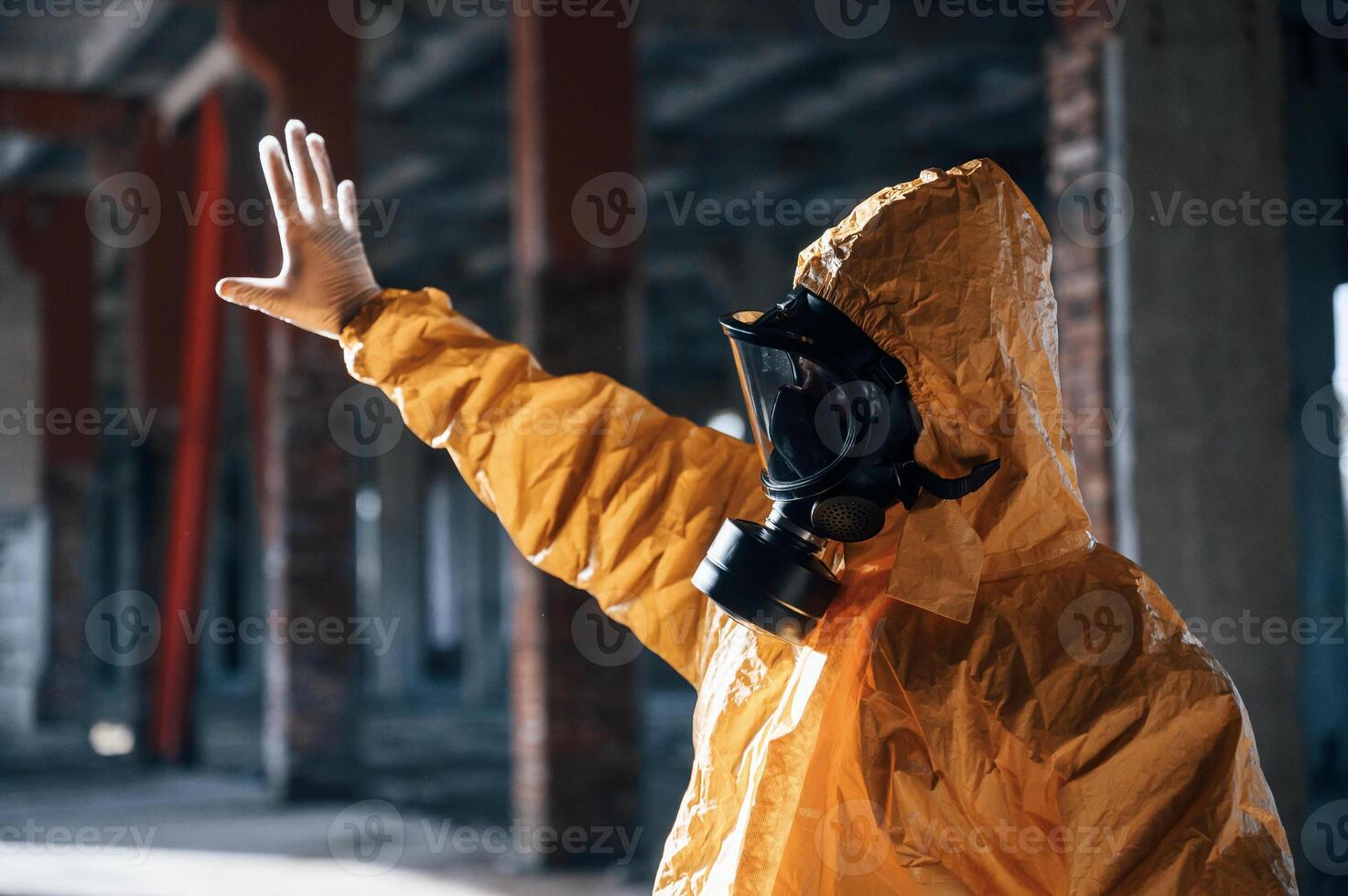 Nuclear explosion. Man dressed in chemical ,,protection suit in the ruins of the post apocalyptic building photo