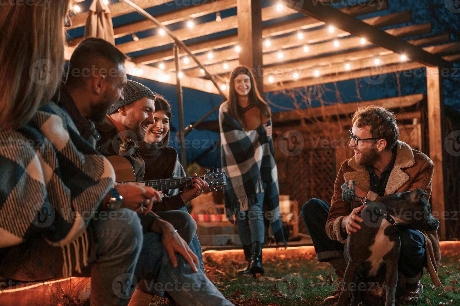 Evening time.. Group, of people is spending time together on the backyard photo