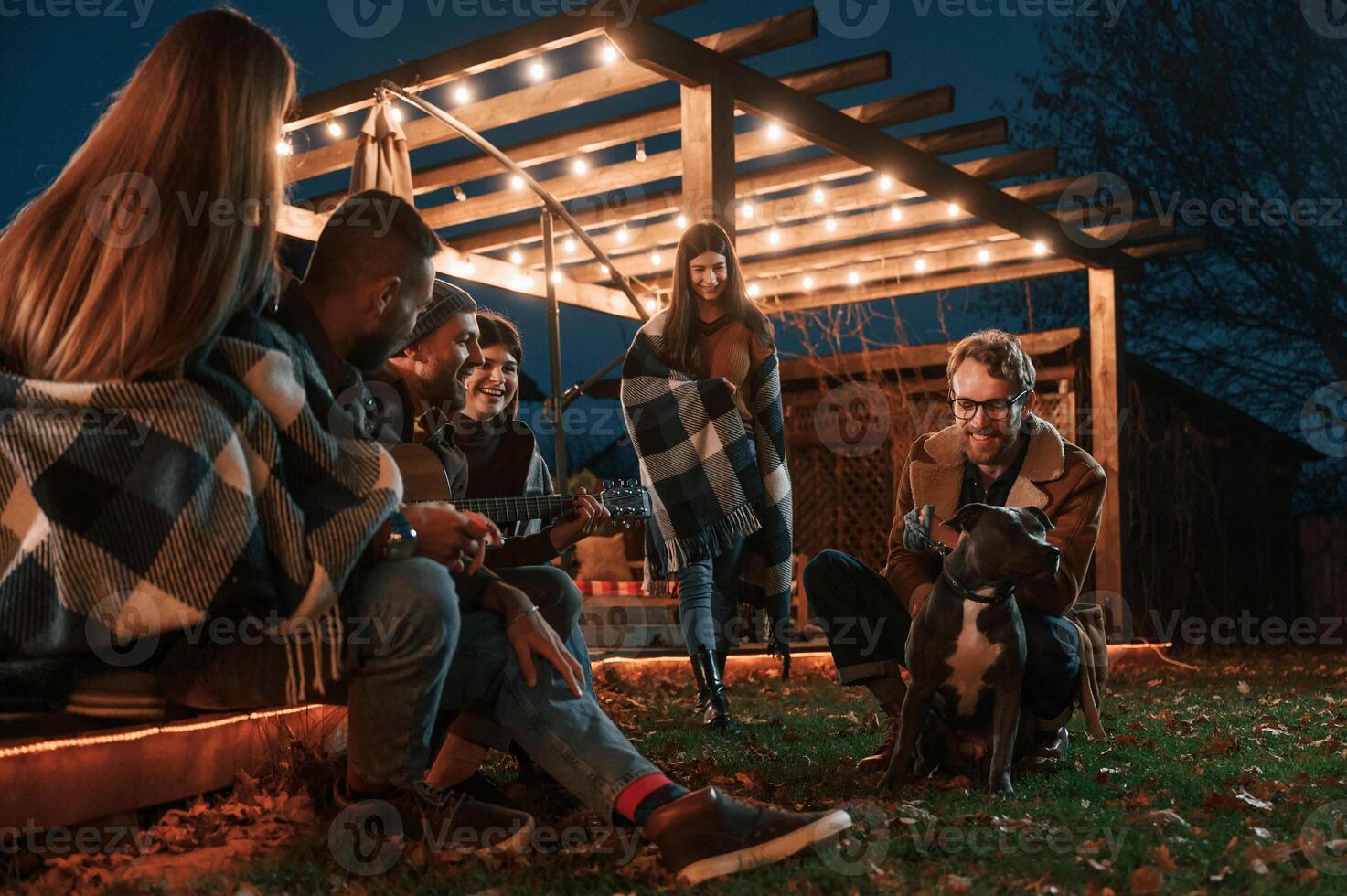 Evening time.. Group of, people is spending time together on the backyard photo