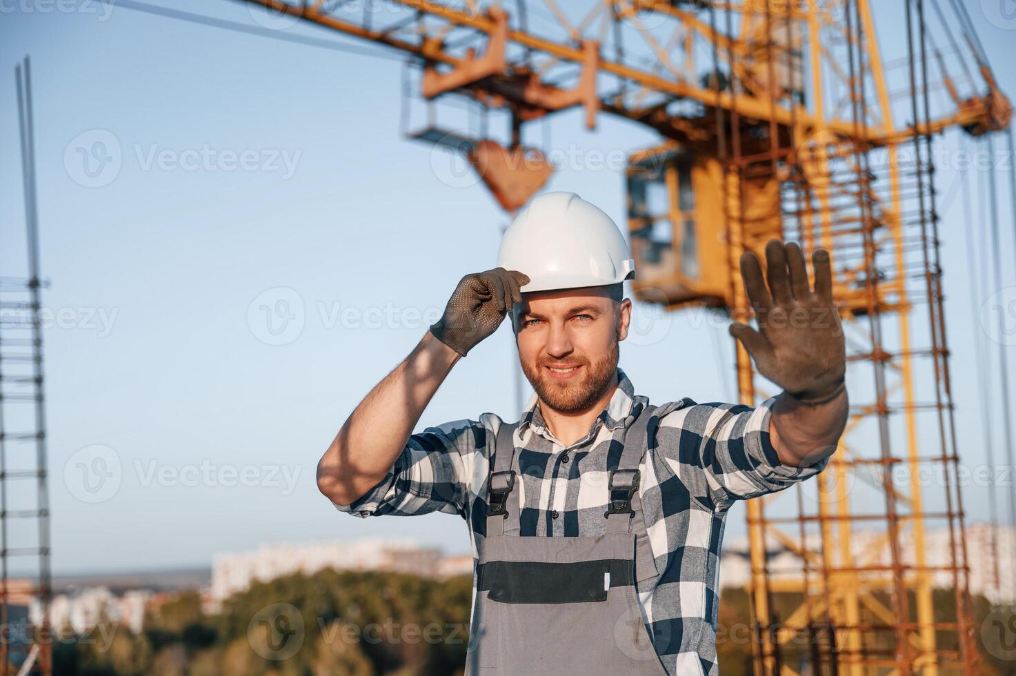 Stop gesture by the hand. Man, is working on the construction site at daytime photo