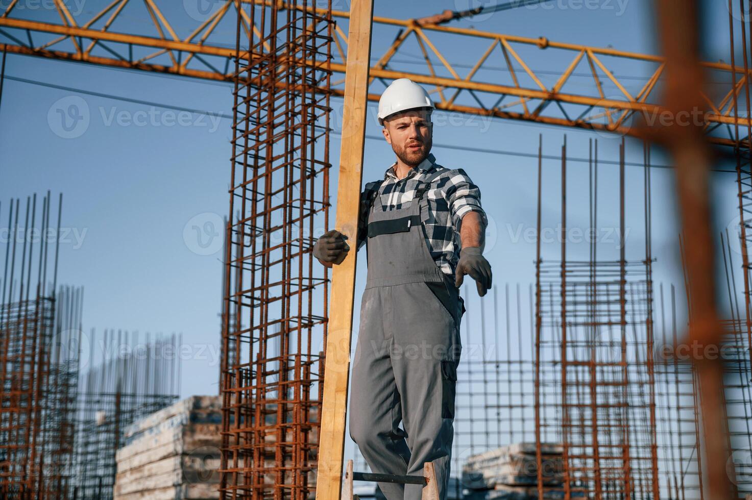 Communicating with othe,r people. Man is working on the construction site at daytime photo