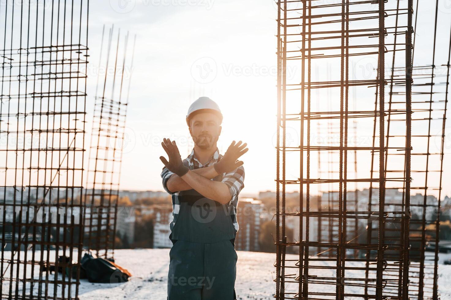 Restricted area. No trespassing. Man is working on ,the construction site at daytime photo