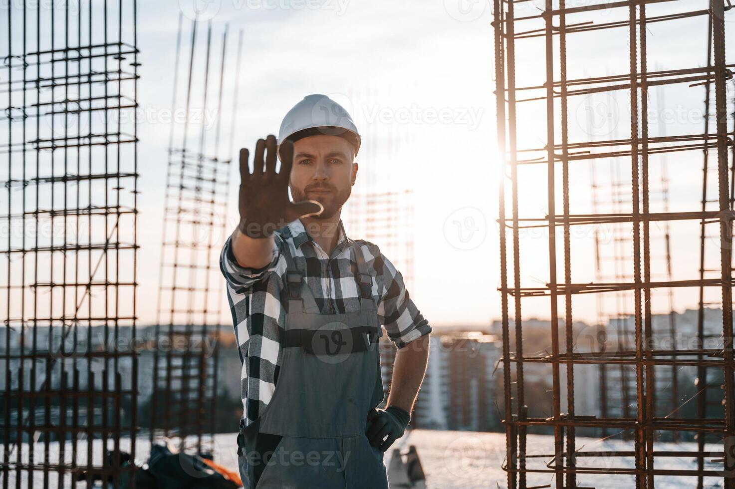 Restricted area,. No trespassing. Man is working on the construction site at daytime photo