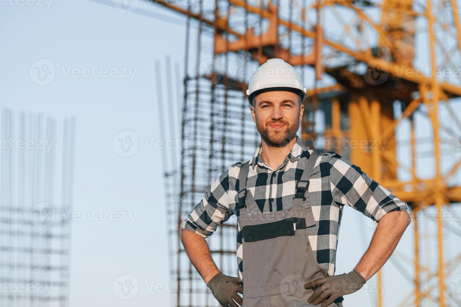 Handsome man is working on the construction site at ,daytime photo