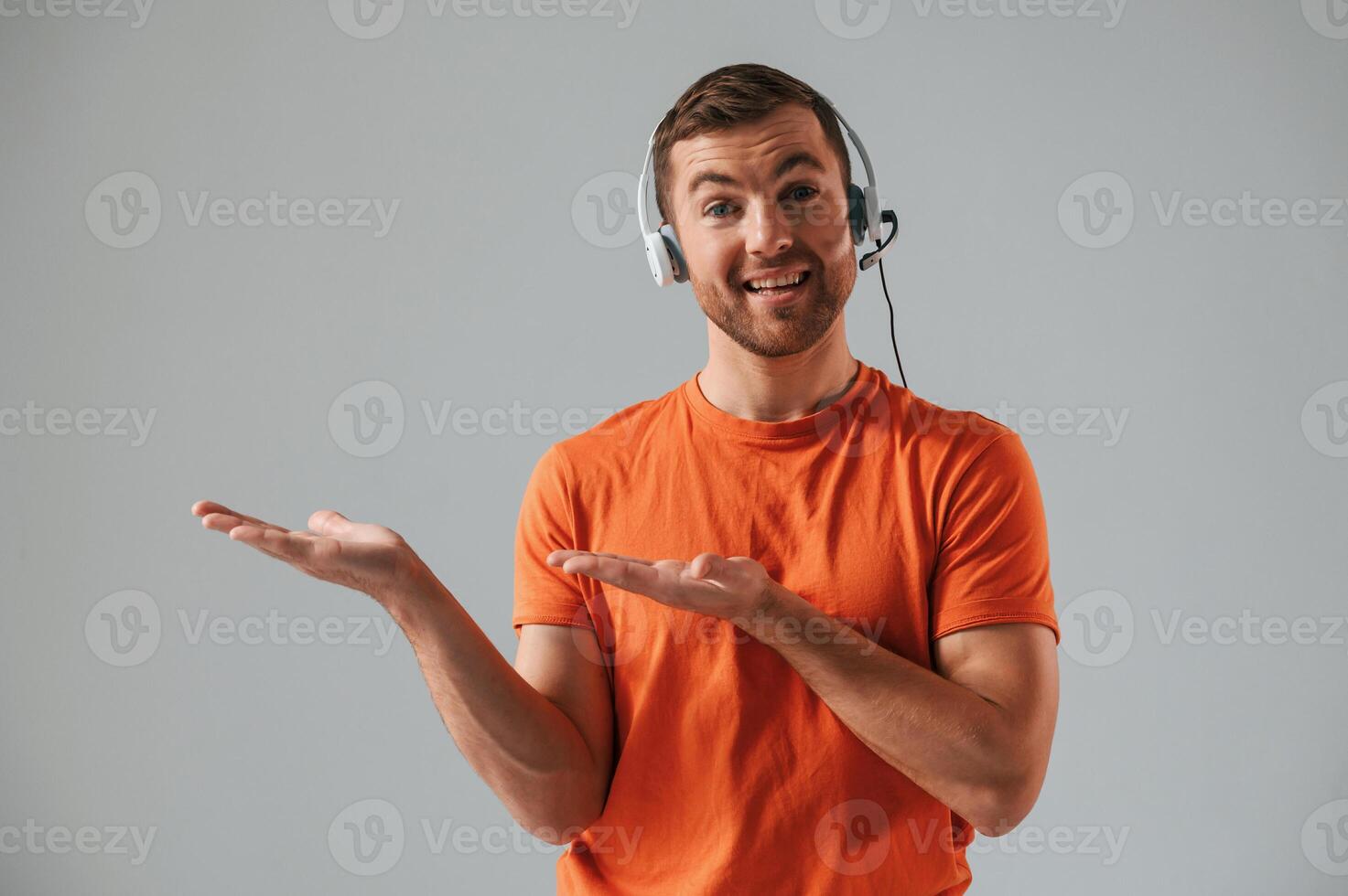 Conception ,,of call center. In headset. Handsome man is in the studio against white background photo