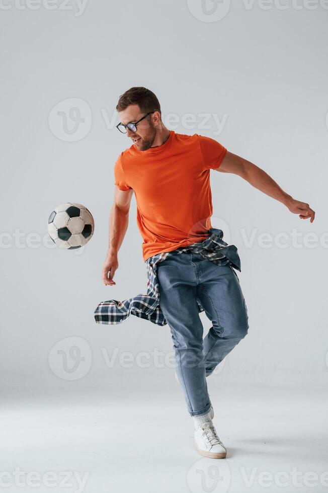 Playing with soccer ,ball. Handsome man is in the studio against white background photo