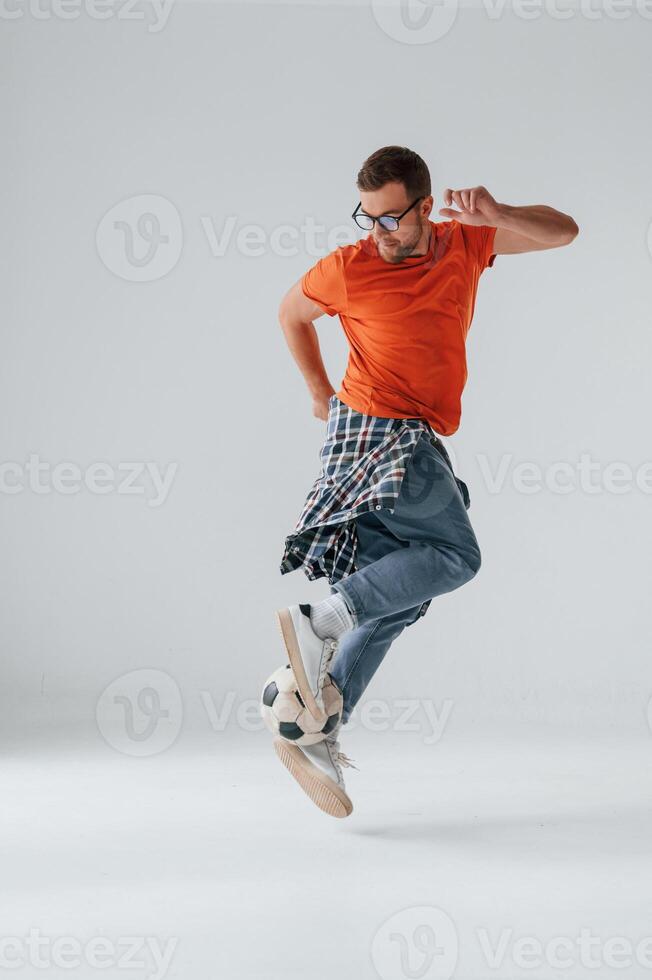 Playing ,with soccer ball. Handsome man is in the studio against white background photo