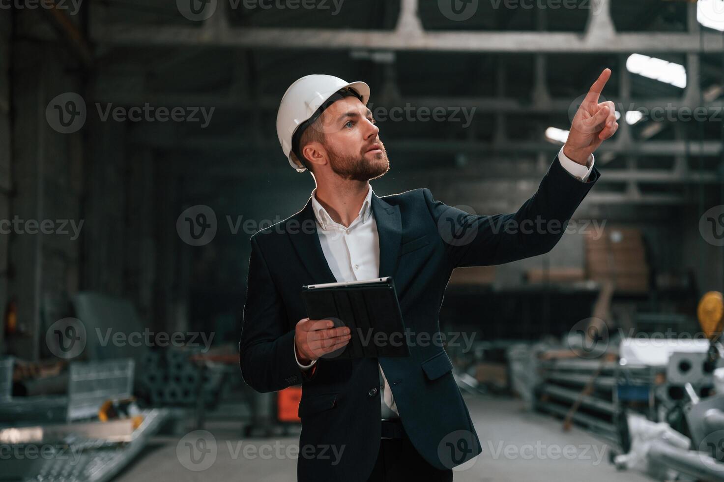 Manager in black formal wear at the factory., photo