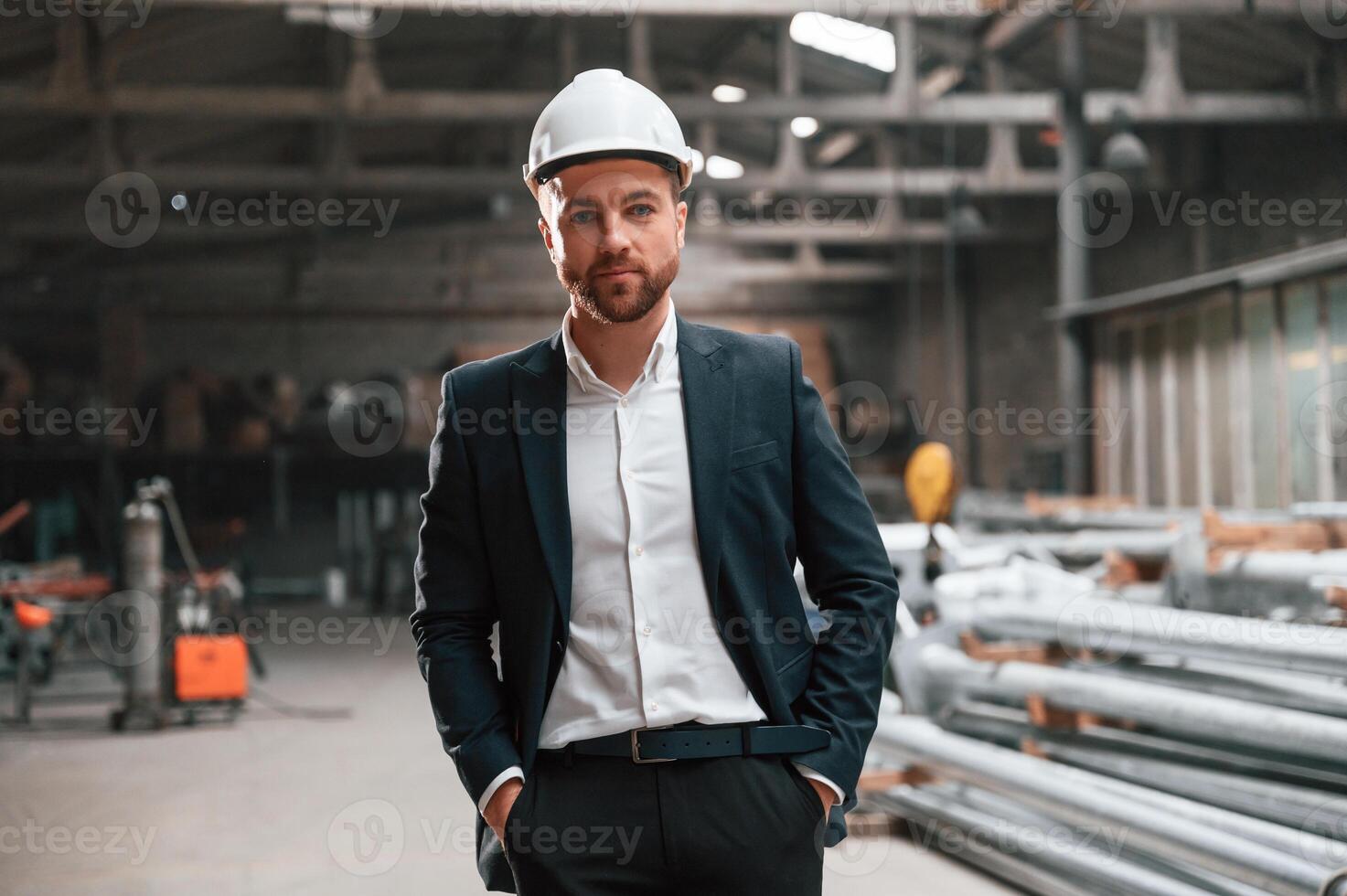 Front view. Manager in ,black, formal wear at the factory photo