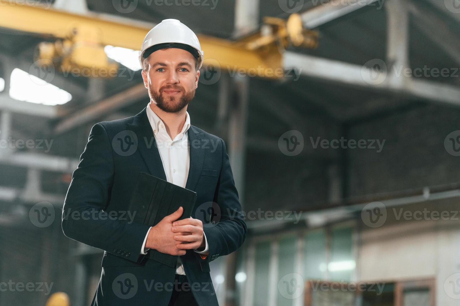 Portrait of manager that is in ,black formal wear at the factory photo