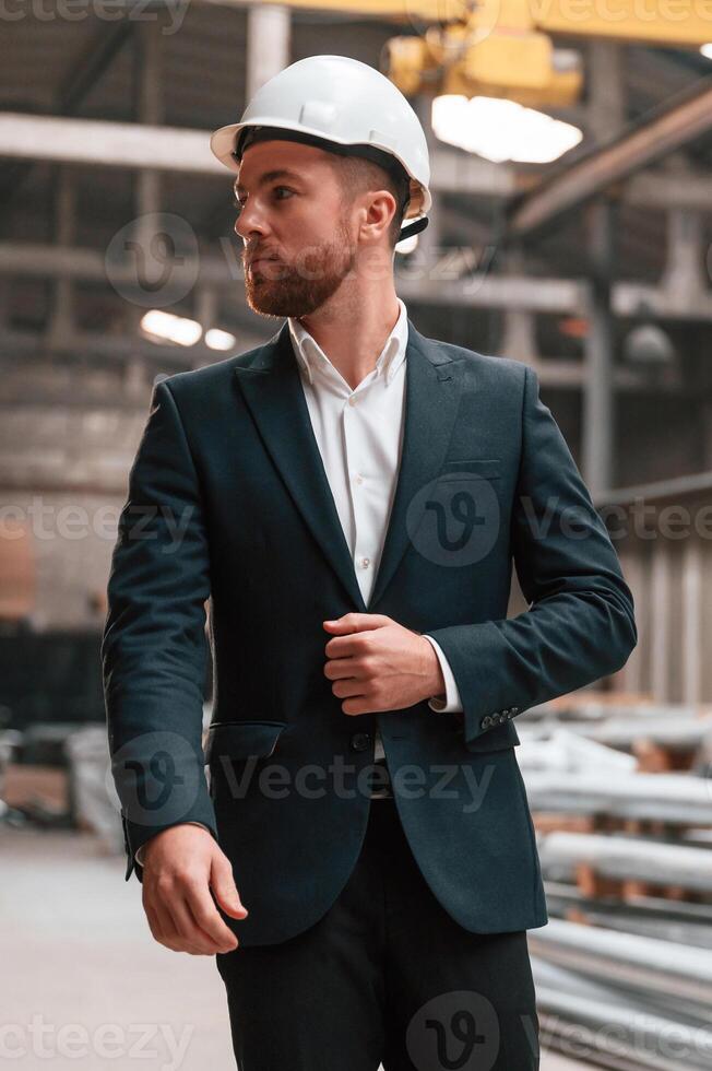 Front view. .Manager in black formal wear at the factory photo