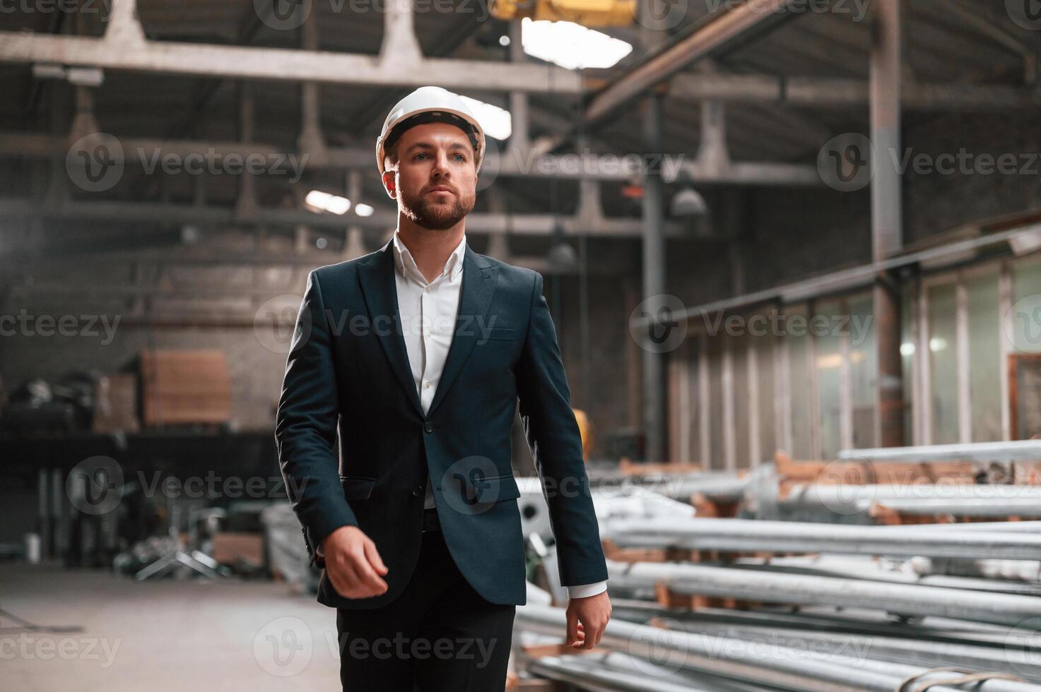 Front view. Manager in black formal ,wear at the factory photo