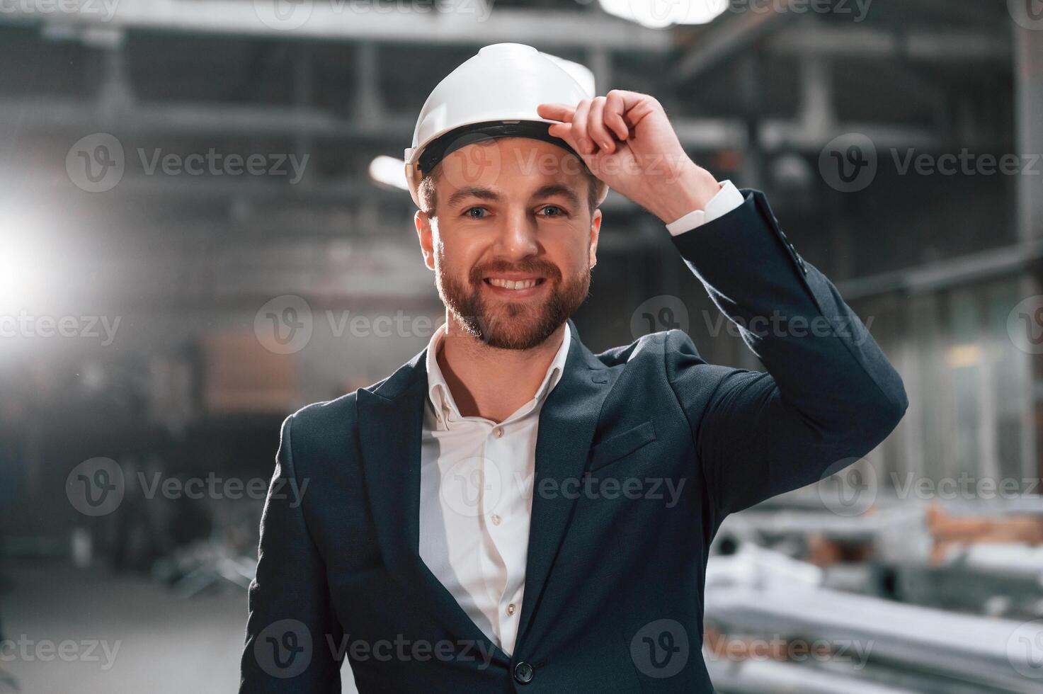 Front, view. Manager in black formal wear at the factory photo