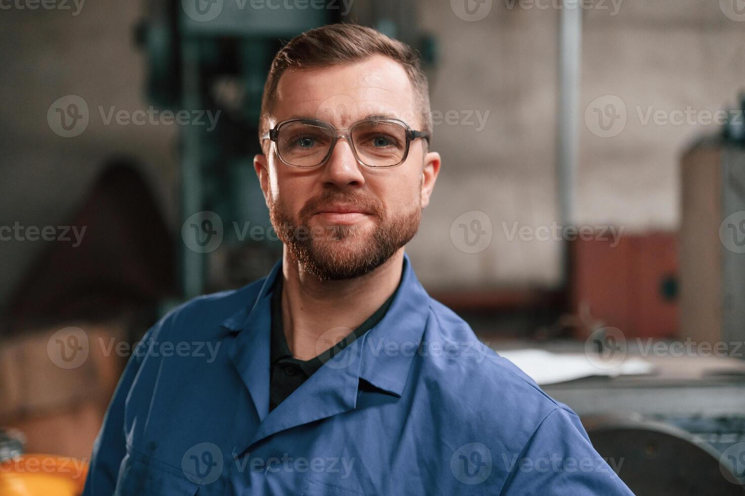Portrait, of ,factory worker that is in blue uniform indoors photo