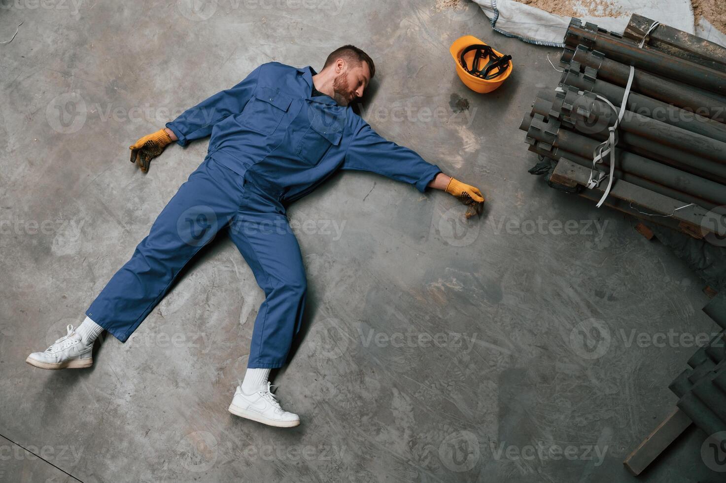 Top view of dead factory ,worker that lying on the ground. Conception of safety, bad accident photo