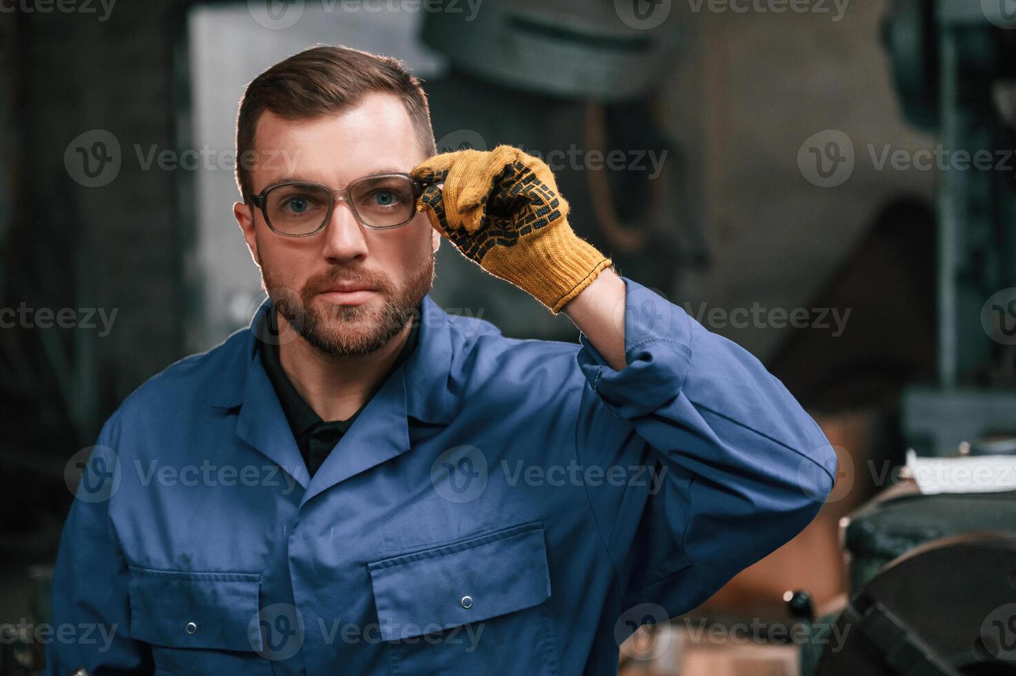 Portrait ,of factory worker that is in blue uniform indoors photo