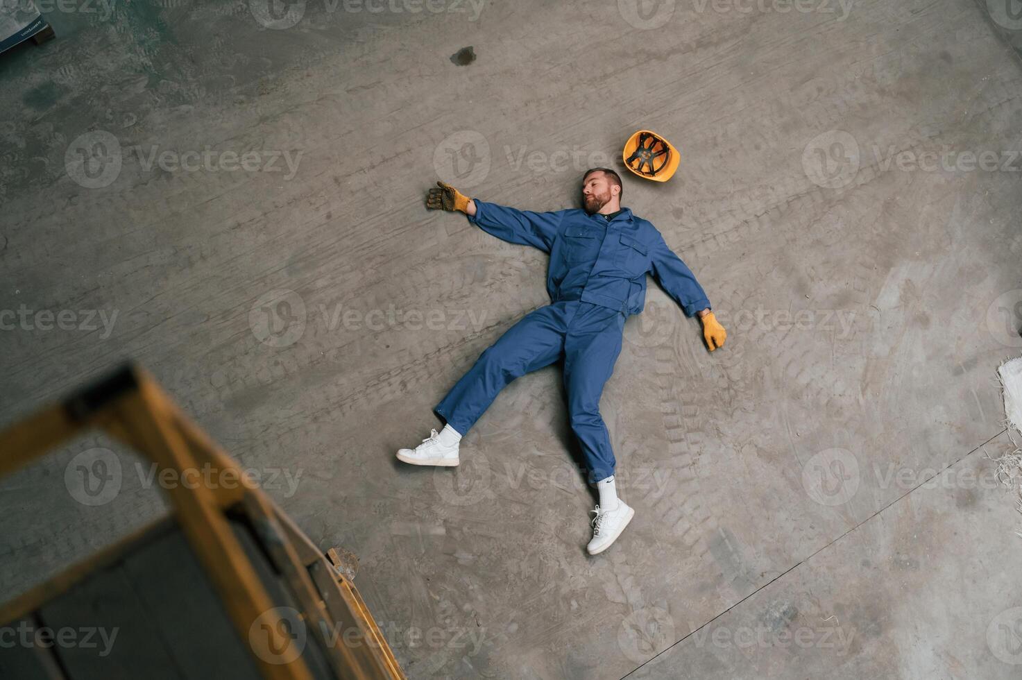 Top view, of dead factory worker that lying on the ground photo