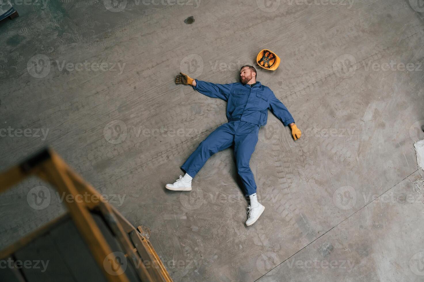 Top view of dead factory worker that lying on ,the ,ground photo