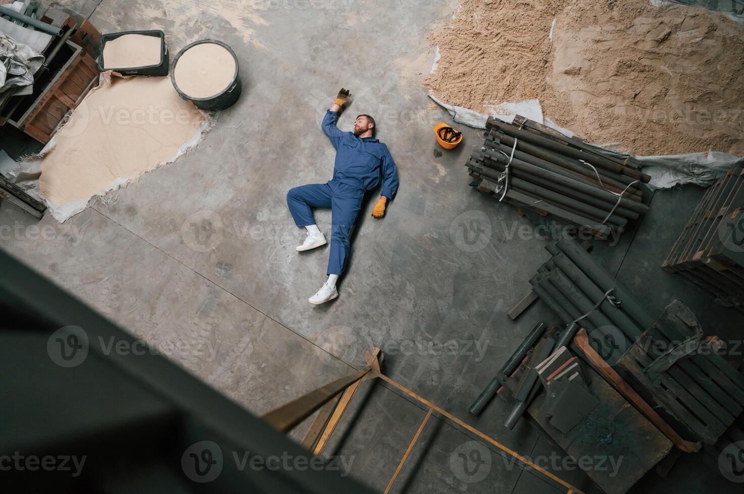 Top view ,of dead factory, worker that lying on the ground. Conception of safety, bad accident photo