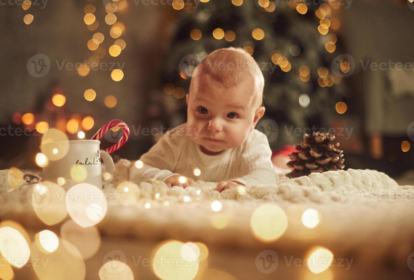 Front ,view. Beautiful, portrait. Cute little baby is at home. New year decorations. Conception of holidays photo