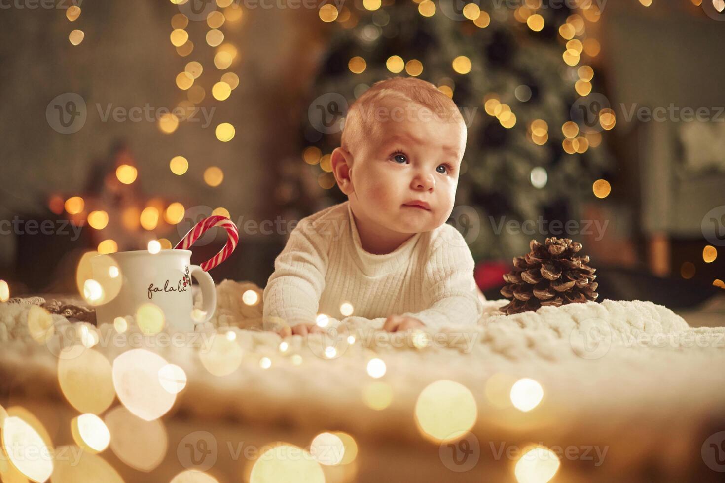 Front view.. Beautiful portrait. Cute little baby is at home. New year decorations. Conception of holidays photo