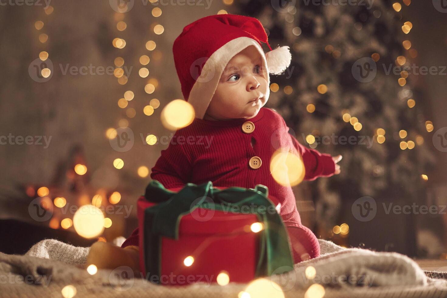 With, gift box. Cute little baby is at home. New year decorations. Conception of holidays photo