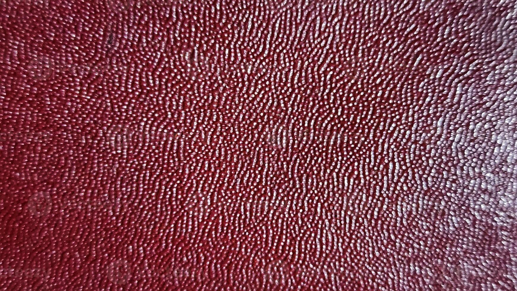 a close up of a red leather surface photo