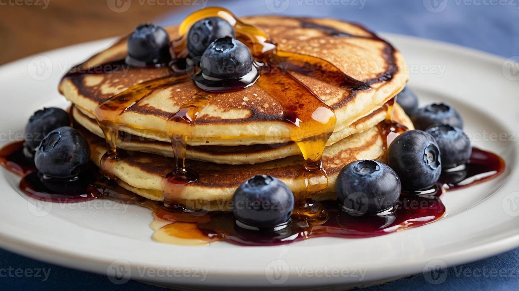 Stack of Pancakes with Fresh Blueberries and Maple Syrup Drizzle photo