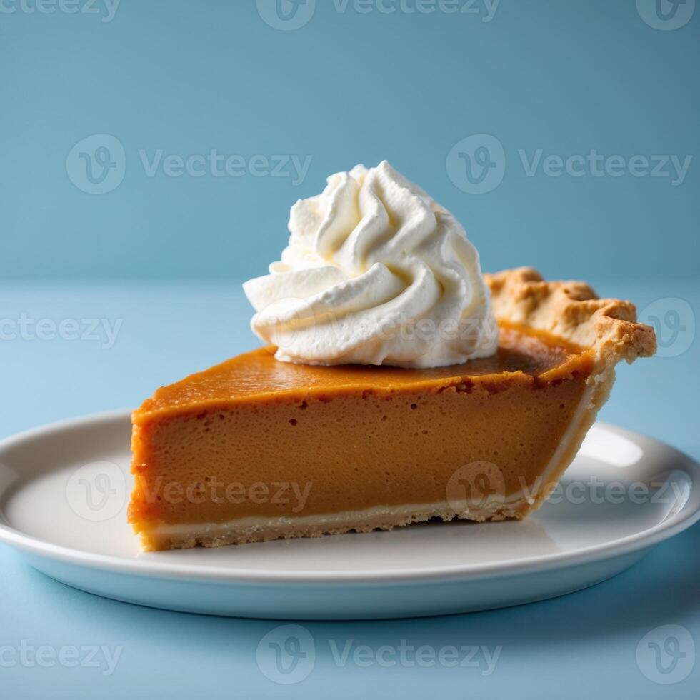 A Delicious Slice of Pumpkin Pie with Whipped Cream on a Blue Background photo