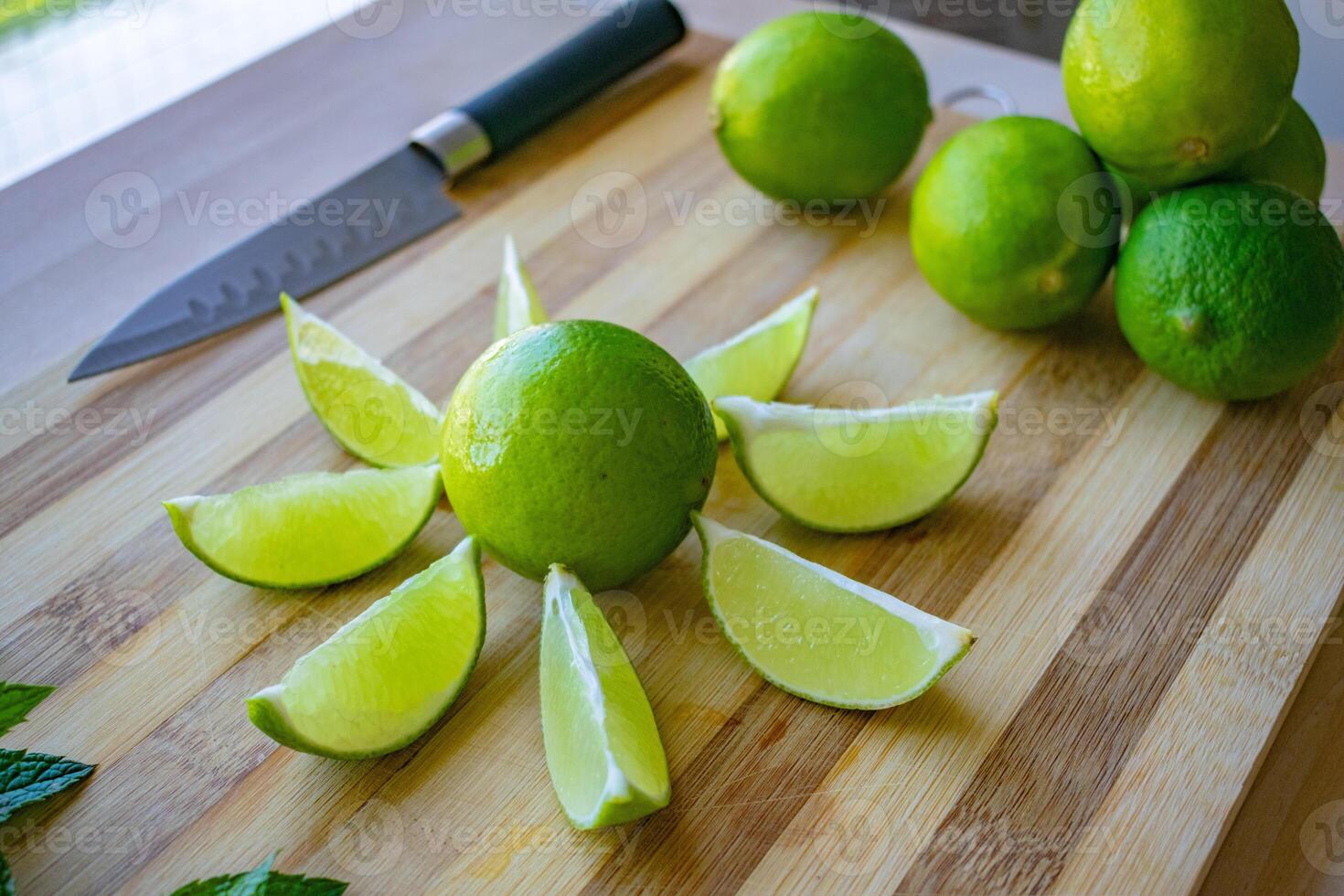 a close up image of sliced limes on a chopping board photo