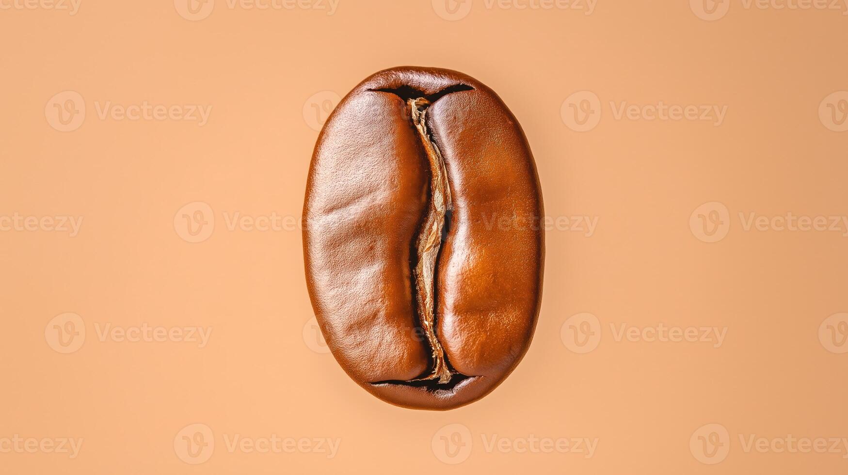Roasted coffee bean on warm pink background, with copy space photo