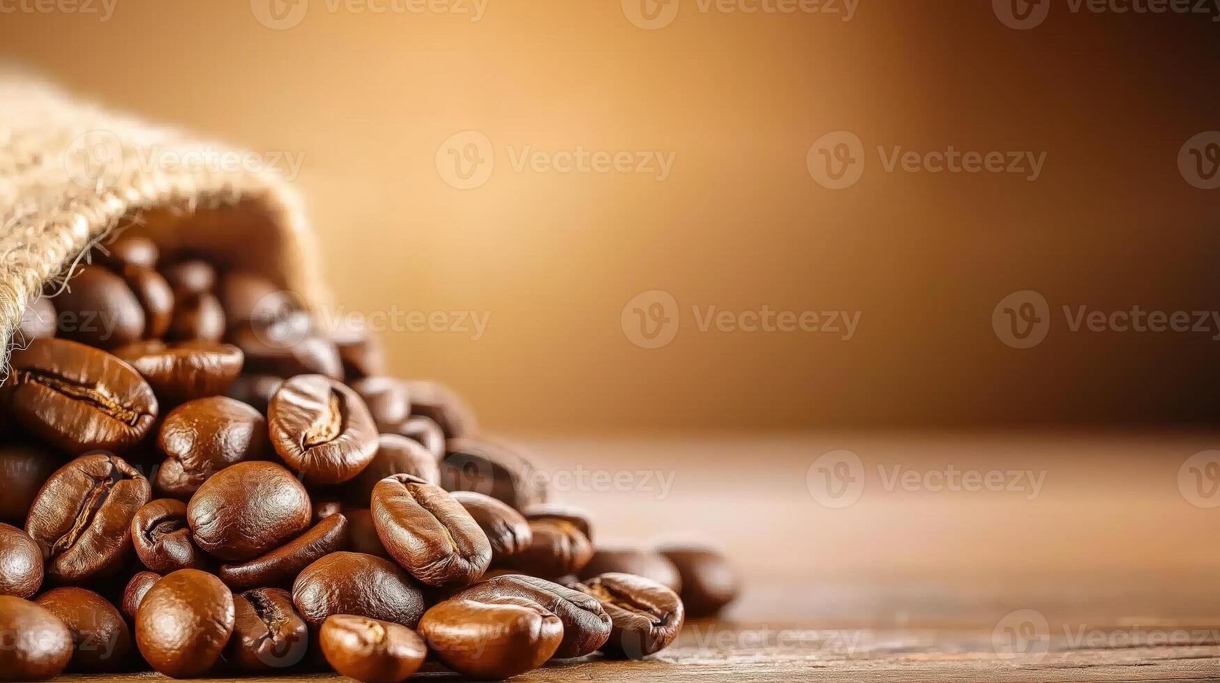 Roasted coffee beans spilling from burlap sack on warm brown background, with copy space photo