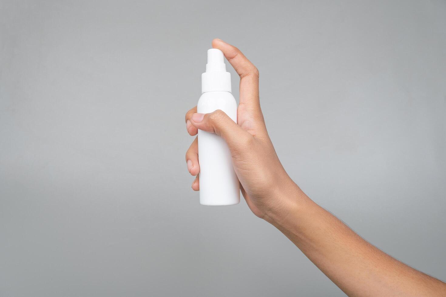 Quick-Absorbing SPF Spray Sunscreen Mockup in Womans Hand for Sun Care Isolated Background photo